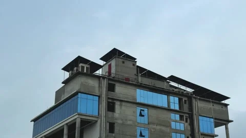 Modern architectural building with blue glass panels against a cloudy sky b.. Stock Footage 340056005