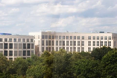 A Modern Architectural Building Elegantly Surrounded by Lush Trees Stock Photos