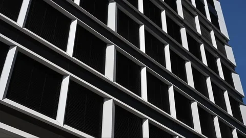 Modern architectural building facade with white frames and dark glass Stock Footage 331581976