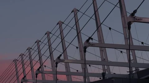 Modern Architectural Cable Structure at Sunset with Slow Downward Pan Stock Footage 337647029