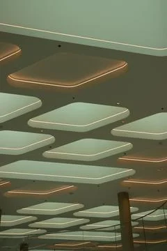 Modern architectural ceiling with lighting in low angle vertical view Stock Photos