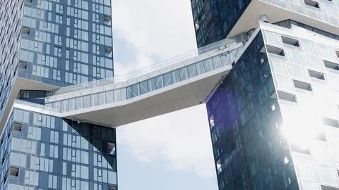 Modern architectural design featuring two skyscrapers connected by a glass Stock Photos