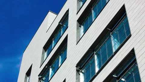 A modern architectural design featuring windows against the skyline,animation 스톡 동영상 341590782