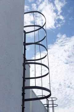 Modern Architectural Elements with an Intriguing Spiral Fire Escape Ladder Stock Photos