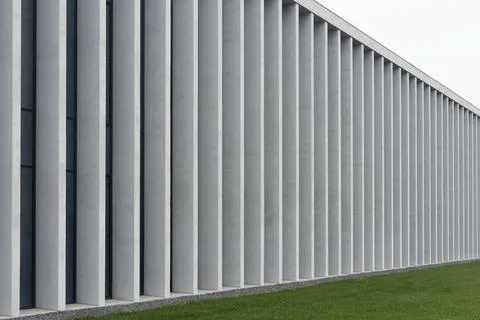 Modern architectural facade with concrete columns forming geometric rhythm. Stock Photos