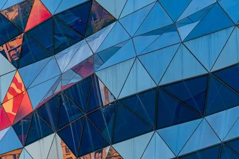 Modern Architectural Facade with Dynamic Triangular Panels Stock Photos