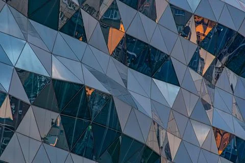 Modern Architectural Facade with Geometric Triangular Panels Stock Photos