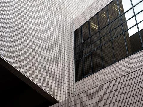 Modern architectural facade with repeating ceramic tile and glass windows f.. Stock Photos