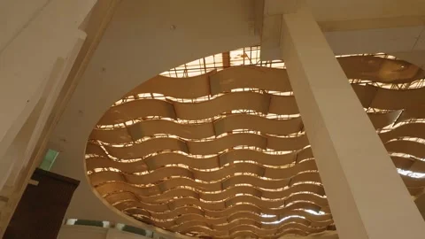 Modern architectural interior design with decorative wavy wooden ceiling panels  Video stock 343415345