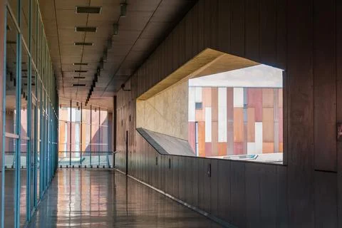 Modern architectural interior with geometric windows and reflections. Coper.. Stock Photos