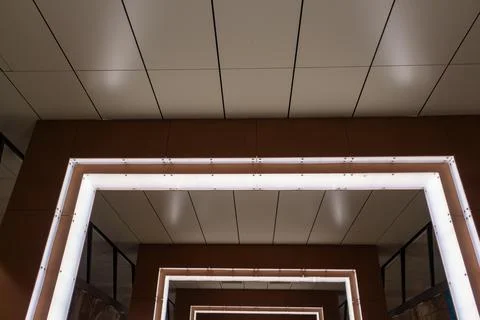 Modern architectural interior with glowing square light frames and geometry Stock Photos