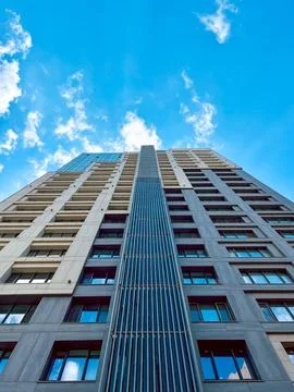 Modern Architectural Marvel Reaching for the Sky Beneath a Bright Blue Sky .. Stock Photos