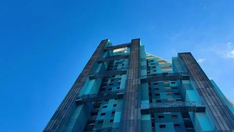 This modern architectural marvel showcasing a stunning blue hue stands out .. Stock Photos
