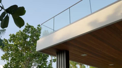 Modern architectural structure with glass railing on balcony or terrace. Wooden Stock Footage 293850269