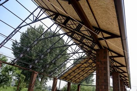 Modern architectural structure with metal framework and wooden panels Stock Photos