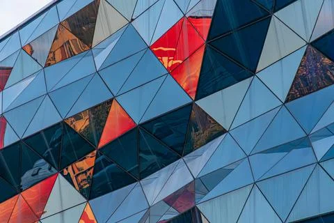 Modern Architectural Structure with Triangular Panels and Dynamic Reflections 스톡 사진