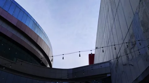 Modern Architectural Structures with Clear Sky and String Lights Overhead Video stock 307930577