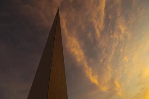 Modern architectural tower with sharp geometric design against sky during sunset 스톡 사진