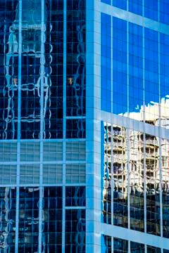 Modern architecture concept, skyscraper reflections in high rise building. Stock Photos