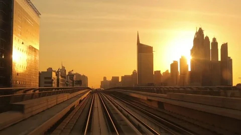 Modern architecture of Dubai, UAE, at sunset seen from a metro train Vídeos de archivo 82344682
