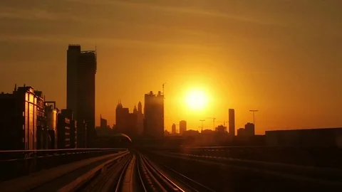 Modern architecture of Dubai, UAE, at sunset seen from a metro train Stock Footage 82345159