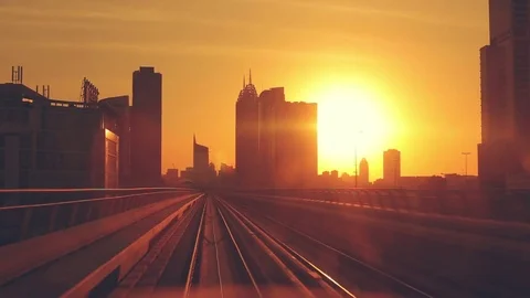 Modern architecture of Dubai, UAE, at sunset seen from a metro train. Video stock 82345252