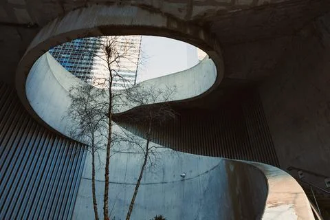 Modern architecture features a circular opening with a tree inside a concre.. Stock Photos