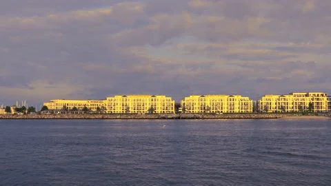 Modern architecture panorama - sunset cloudy sky - passenger ship passes by Stock Footage 140660473
