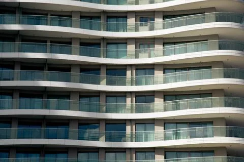 Modern architecture showing repeating rounded balconies and windows Фото