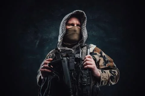 Modern army agent in camouflage clothing with a hood and rifle Stock Photos
