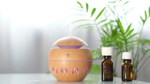 Modern aroma oil diffuser on the white table. Spa concept for body and health Stock Footage 170717080