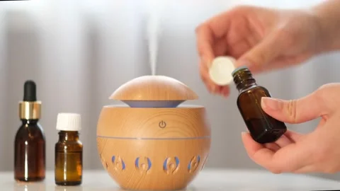 Modern aroma oil diffuser on the white table. Spa concept for body and health Stock Footage 171161244