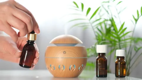 Modern aroma oil diffuser on the white table. Spa concept for body and health Stock Footage 171228021