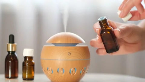 Modern aroma oil diffuser on the white table. Spa concept for body and health Stock Footage 171297258
