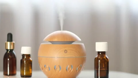Modern aroma oil diffuser on the white table. Spa concept for body and health Stock Footage 171369699