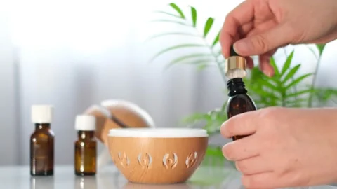 Modern aroma oil diffuser on the white table. Spa concept for body and health Stock Footage 171369757