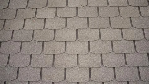 Modern asphalt shingles creating regular tiled roof pattern Stock Photos