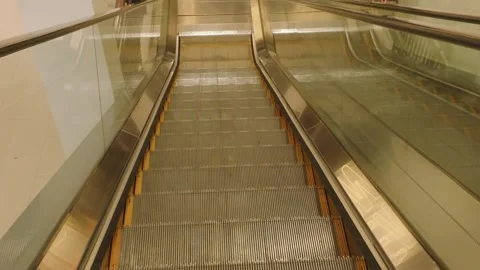 Modern automatic escalator stairs moving downwards inside a public building. Video stock 343375070