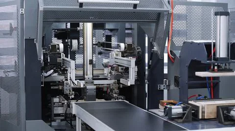 Modern automatic machine line of cardboard box. Conveyor line for the production Stock Photos