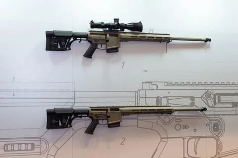 Modern automatic rifles on the wall of a gun shop Stock Photos