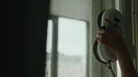 Modern automatic window cleaning robot working on glass window in bright living Stock Footage 311736715