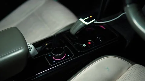 Modern automobile center console with illuminated climate controls and elec.. Stock Footage 346597453