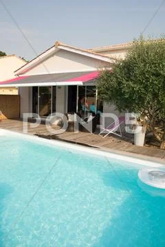 Modern backyard with swimming pool in mansion Stock Photos