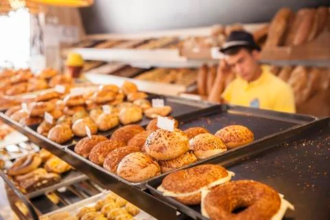 Modern bakery with different kinds of bread, cakes and buns ( selective focus ) Stock Photos
