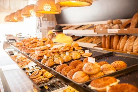 Modern bakery with different kinds of bread, cakes and buns ( selective focus ) Stock Photos