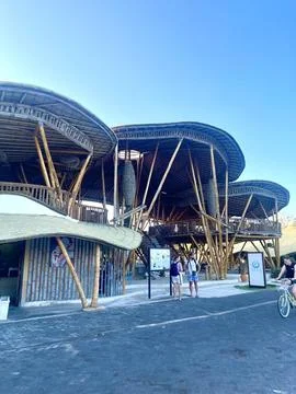 Modern Bamboo Structure With Visitors Outside Under Clear Sky Stock Photos