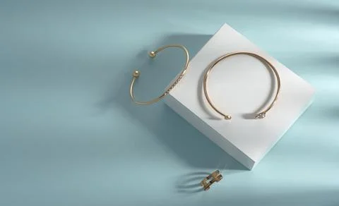 Modern bangles and chain shape ring on white and blue background with copy sp Stock Photos