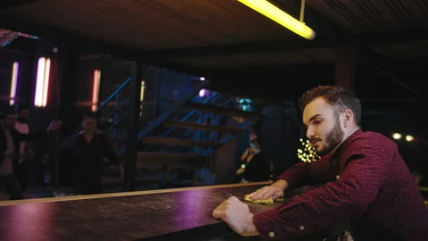 In a modern bar bartender cleaning bar table before customer came than he Stock Footage 135913556