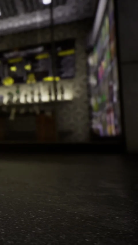 Modern bar interior with numerous drink options displayed at night Stock Footage 334172956