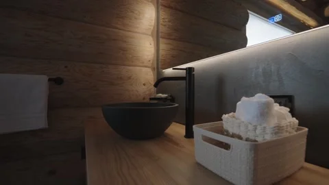 Modern bathroom design featuring a stone sink and wooden vanity in a cozy log Stock-Footage 335756892